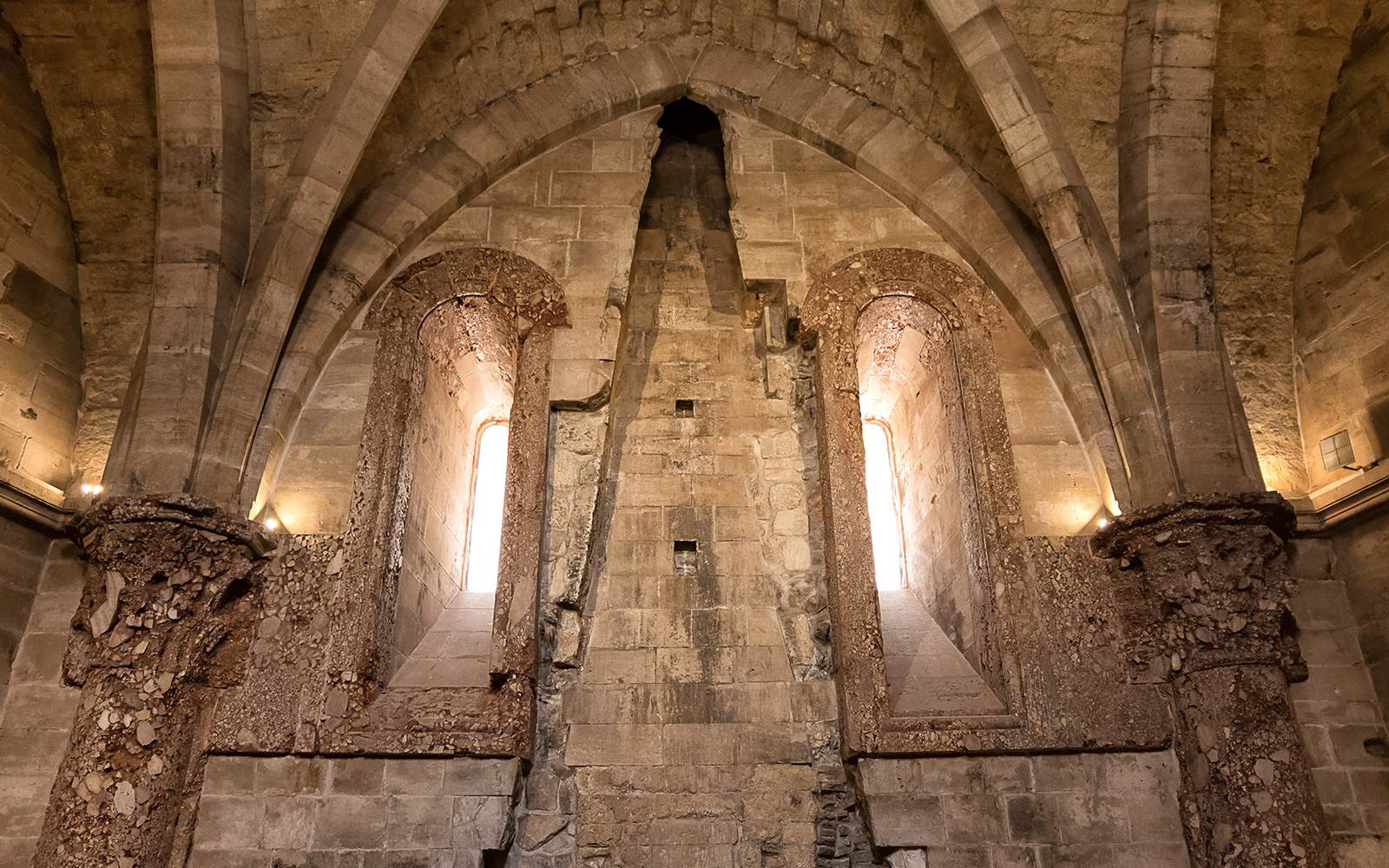 Remnants of a fireplace inside Castel del Monte, Italy, showcasing historical architecture.