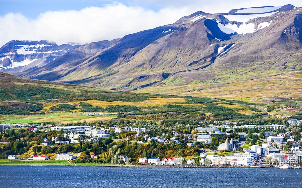 Akureyri cityscape with mountains across Eyjafjörður fjord, north Iceland.