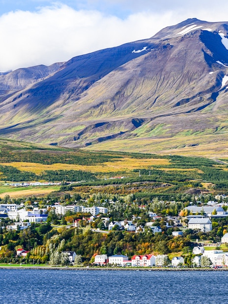 Akureyri cityscape with mountains across Eyjafjörður fjord, north Iceland.