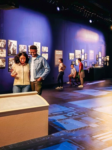 Guide leading tour at Warner Bros. Studio with visitors near iconic water tower.
