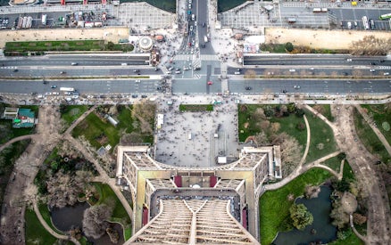 Aerial view from the Eiffel Tower, Paris, showing surrounding streets and gardens.