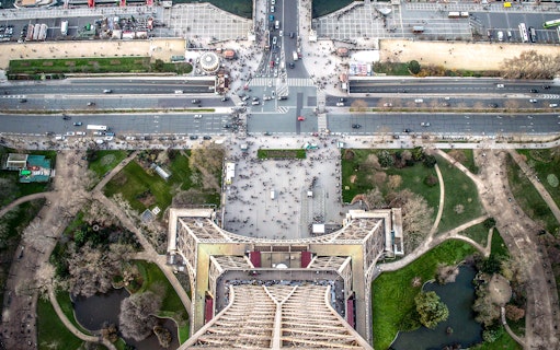 Aerial view from the Eiffel Tower, Paris, showing surrounding streets and gardens.