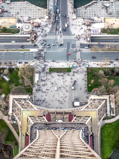 Aerial view from the Eiffel Tower, Paris, showing surrounding streets and gardens.