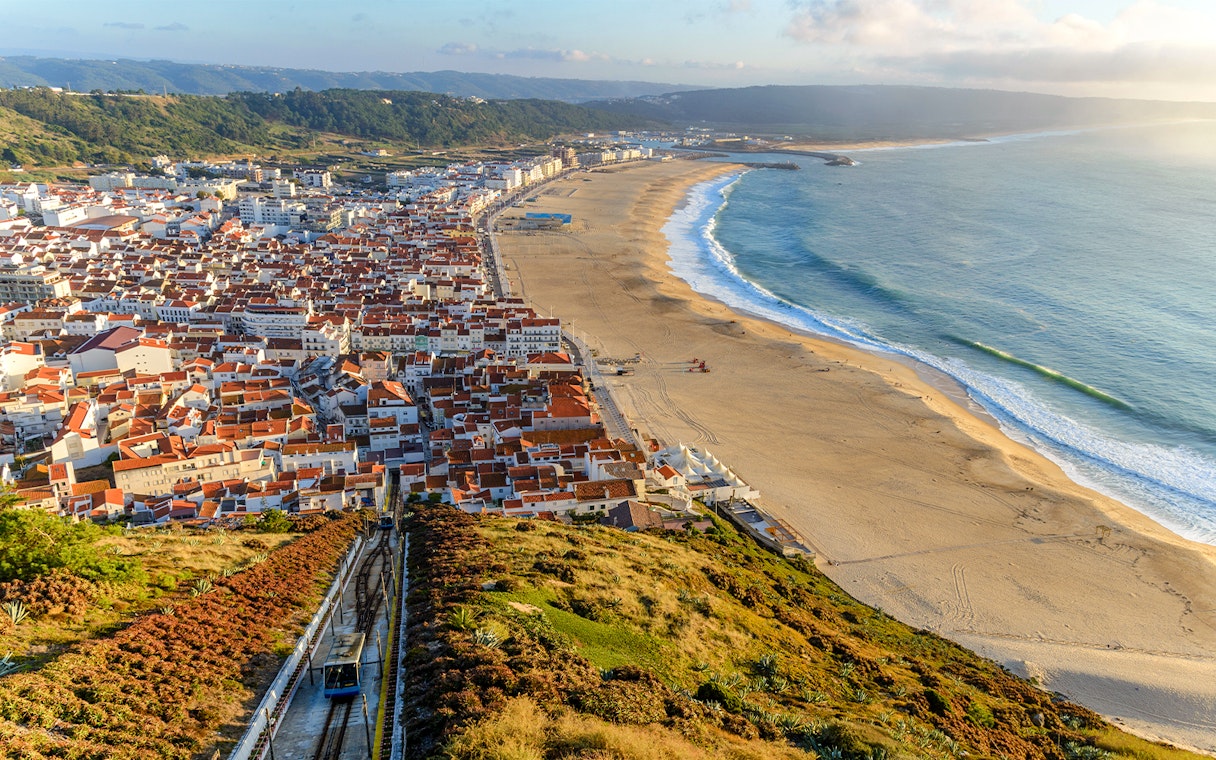 Aerial view of Nazare city and Praia da Nazare Beach, Portugal, with funicular railway.
