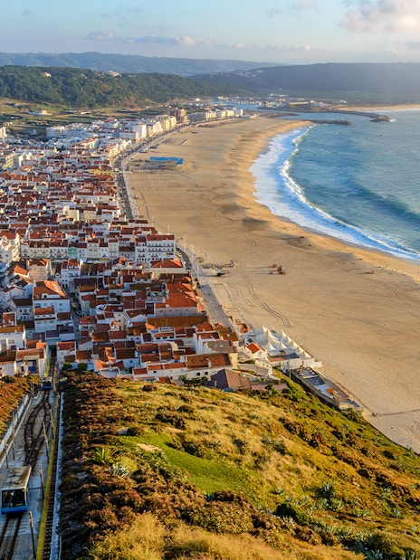 Aerial view of Nazare city and Praia da Nazare Beach, Portugal, with funicular railway.