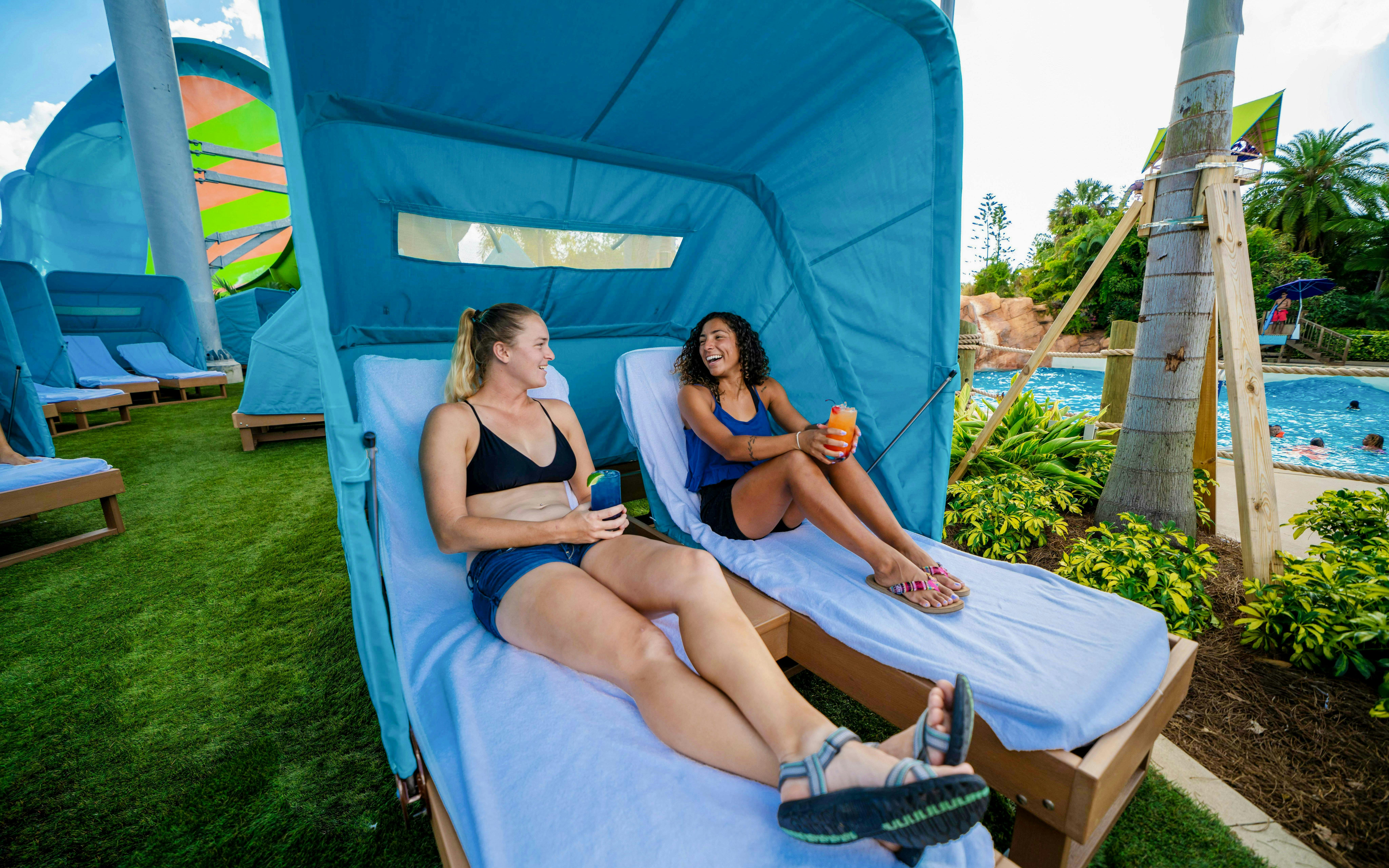 Guests relaxing in cabanas by the pool at Aquatica Orlando.