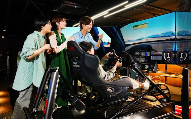 Tourists playing VR racing game at RED TOKYO TOWER.