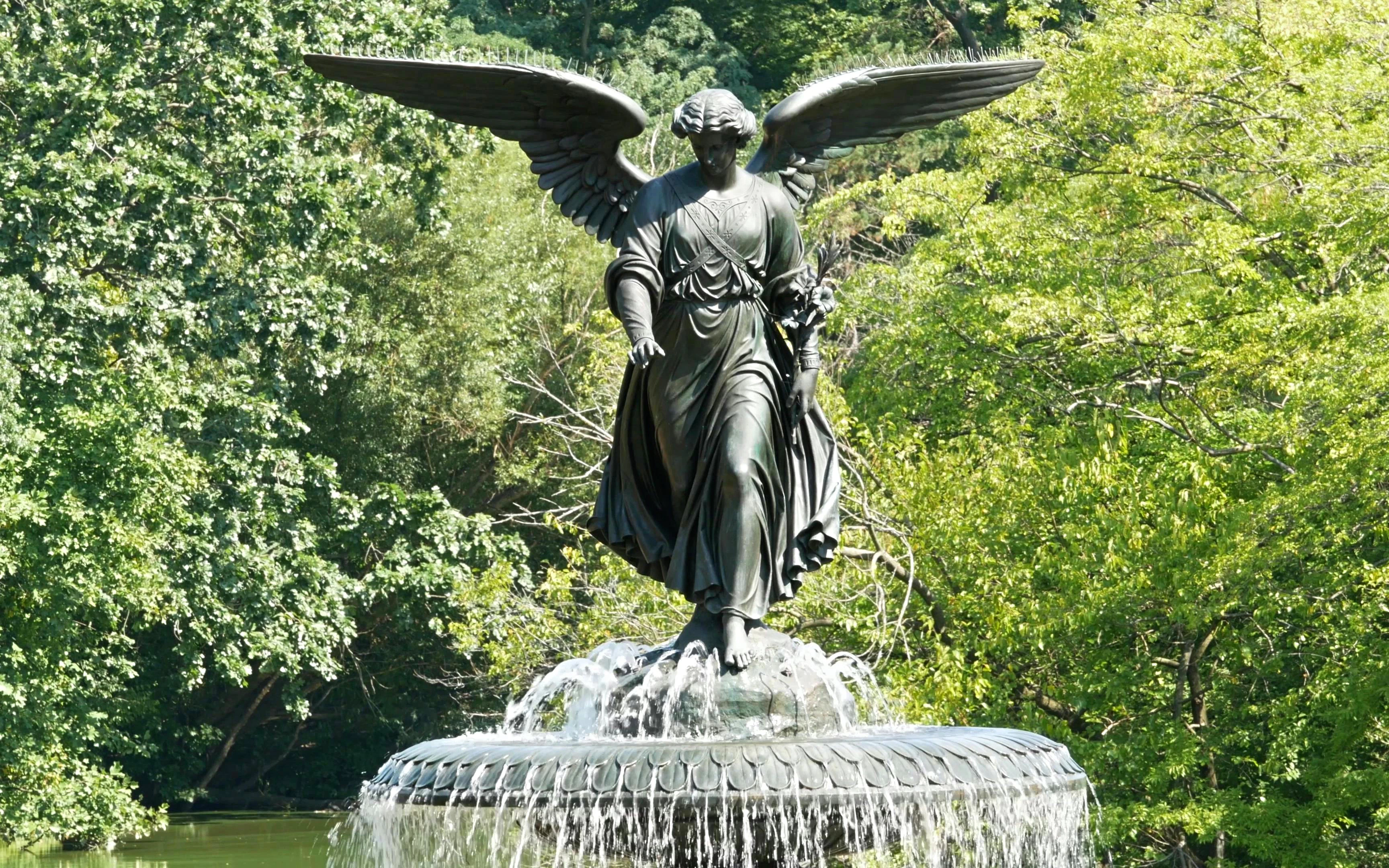 Bethesda Fountain Angel statue in Central Park, New York City, surrounded by trees.