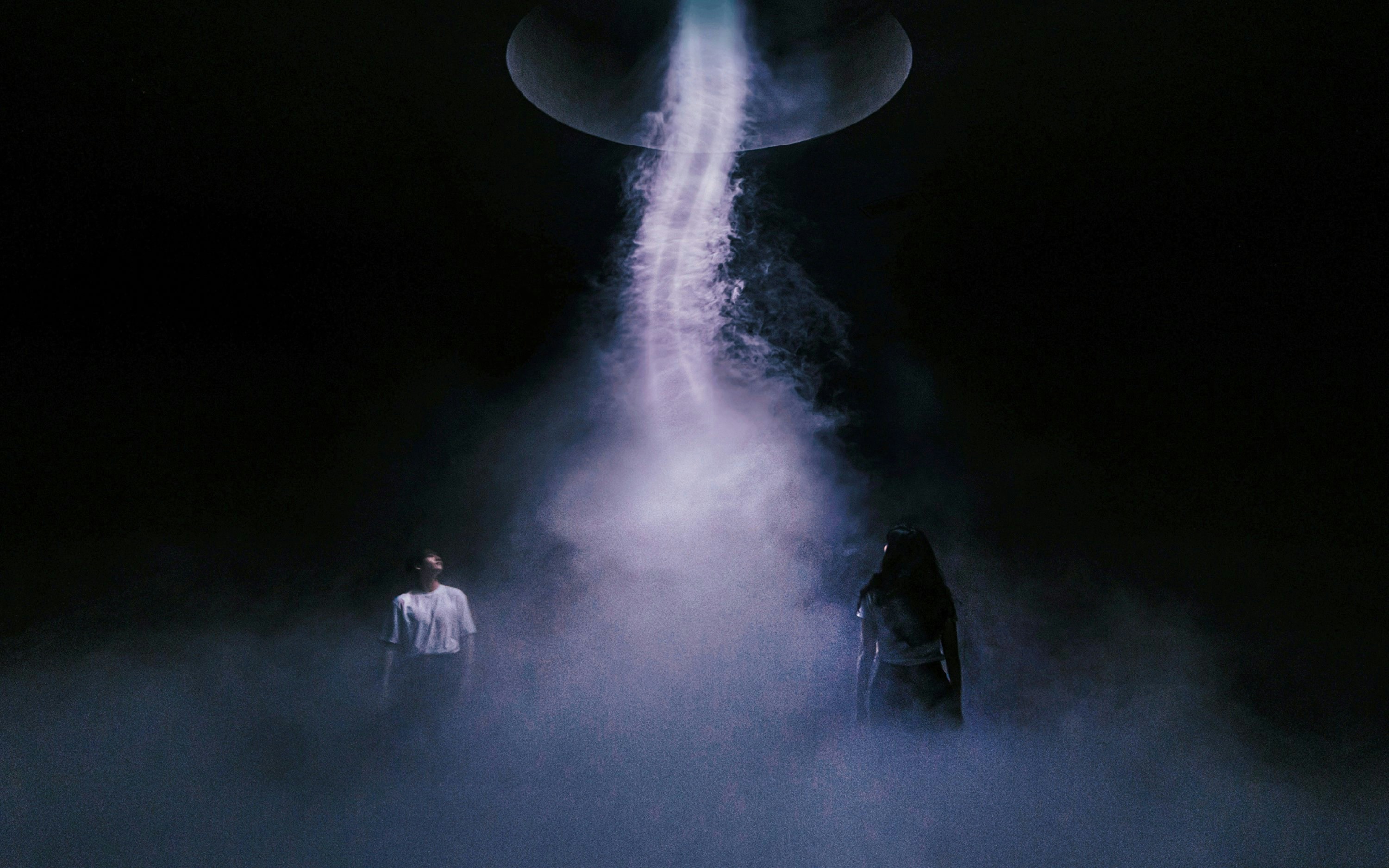 Visitors in misty light installation at Arte Museum, New York.