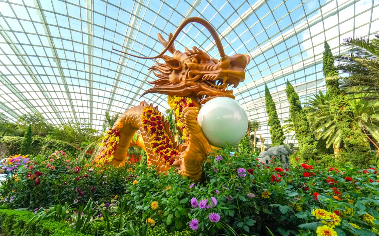 Dragon sculpture surrounded by flowers at Gardens by the Bay, Singapore.