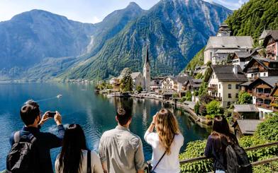 Tourists viewing Hallstatt village and lake with mountains, part of Salzburg to Hallstatt Salt Mine & Skywalk tour.