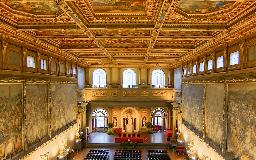 Palazzo Vecchio interior with ornate ceiling and large frescoes, Florence, Italy.