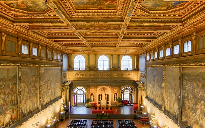 Palazzo Vecchio interior with ornate ceiling and large frescoes, Florence, Italy.