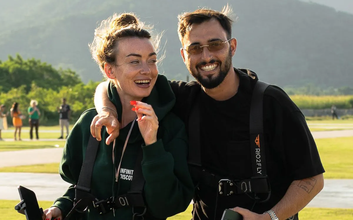 Tourists preparing for Rio de Janeiro helicopter tour with harnesses on.
