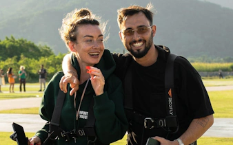 Tourists preparing for Rio de Janeiro helicopter tour with harnesses on.