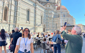 Tourists outside Florence Cathedral, Italy, capturing photos and enjoying the historic architecture.