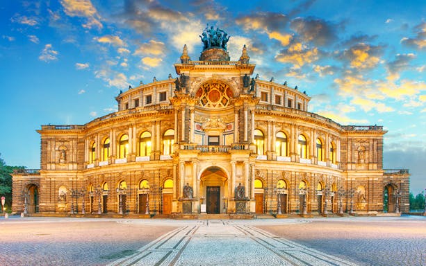 Semper Opera House in Dresden, Germany, illuminated at sunset.