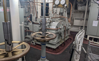 Engine room machinery with gauges and valves on the Escape the Fleet Adventure tour.