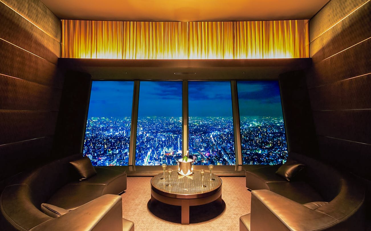 Sky Restaurant 634 Grand Room with city skyline view at night.