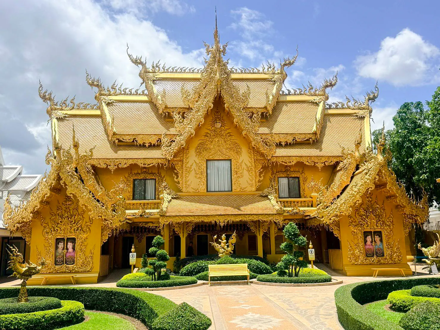 Golden temple facade with intricate carvings in Chiang Rai, part of Chiang Mai to Chiang Rai tour.