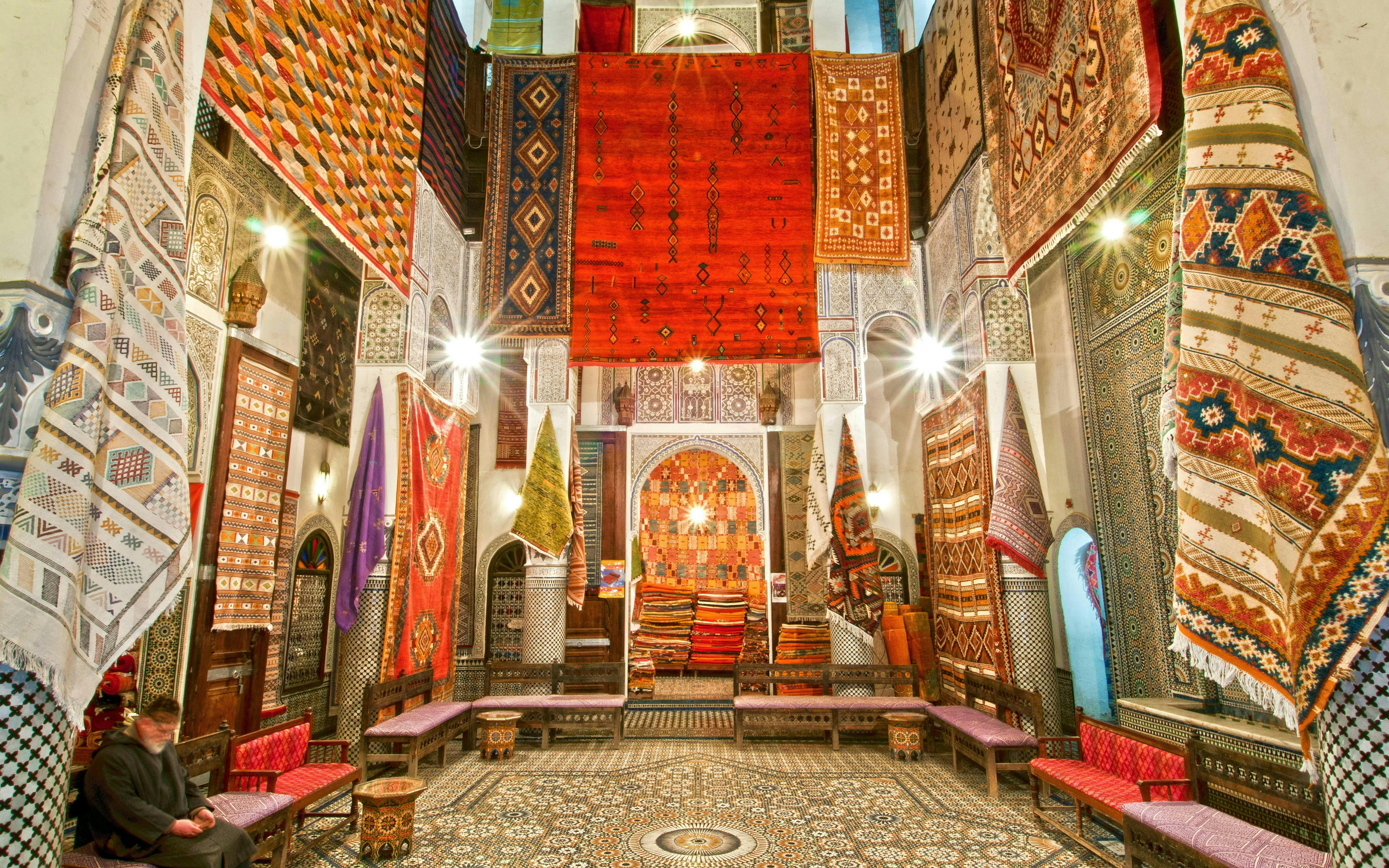 Colorful rugs displayed in a shop in Fes Old Medina, Morocco.