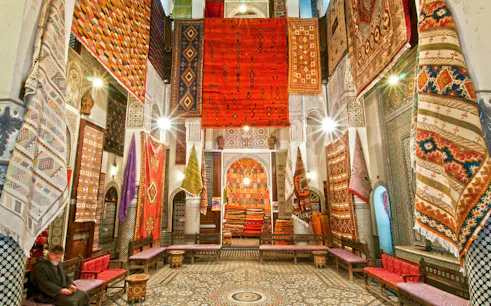 Colorful rugs displayed in a shop in Fes Old Medina, Morocco.
