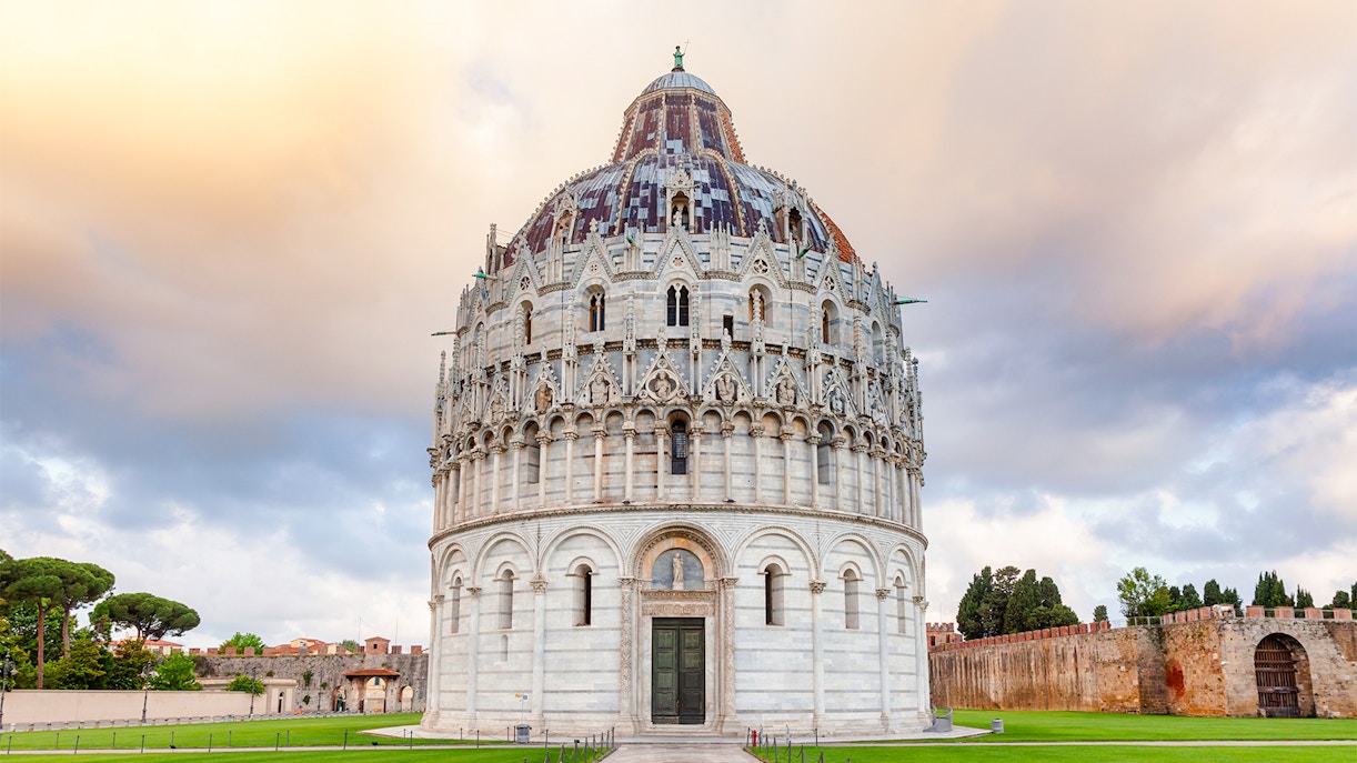 Tourists exploring the historic Pisa Baptistery, an iconic landmark in Italy offering a unique cultural experience