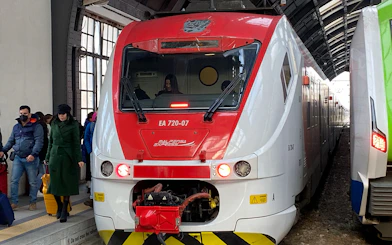 Malpensa Express train at platform with passengers, connecting airport to Milan Central Station.