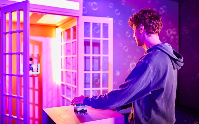 Person interacting with an exhibit at Bubble Planet, Washington DC.