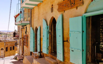 Historic street in As-Salt with colorful shutters, part of the Half-Day Harmony Trail from Amman.