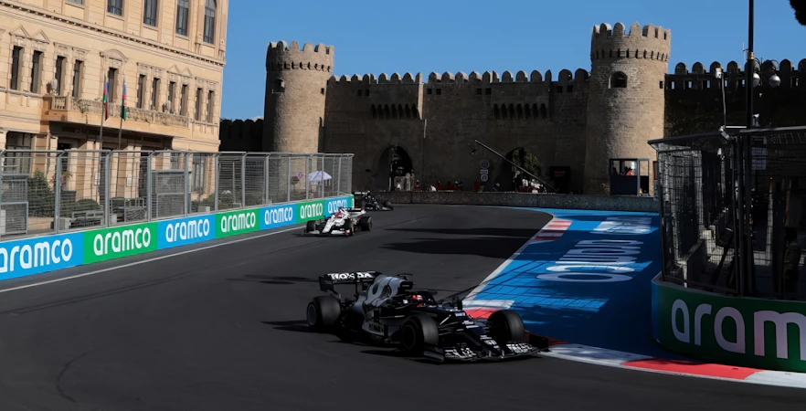 Formula 1 cars racing past Baku's historic city walls during Azerbaijan Grand Prix 2026.