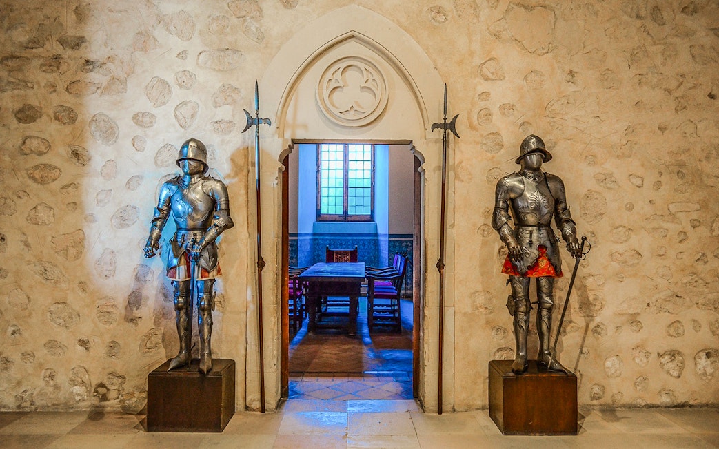 Suits of armor in a historic room, Segovia & Avila Day Trip from Madrid.