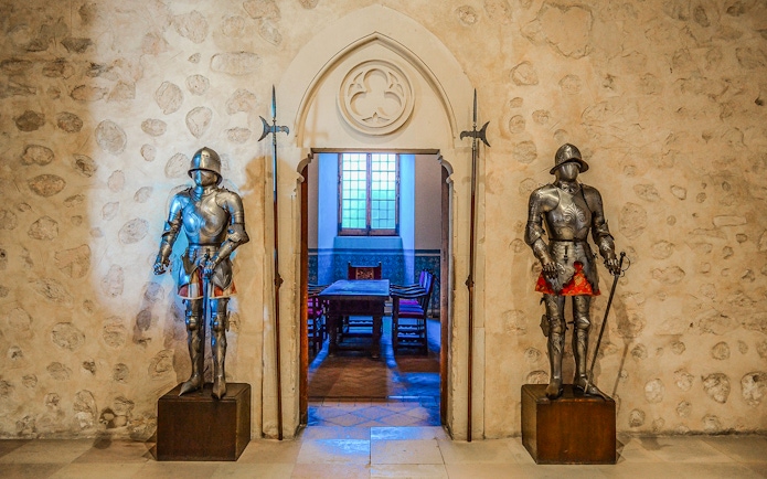 Suits of armor in a historic room, Segovia & Avila Day Trip from Madrid.