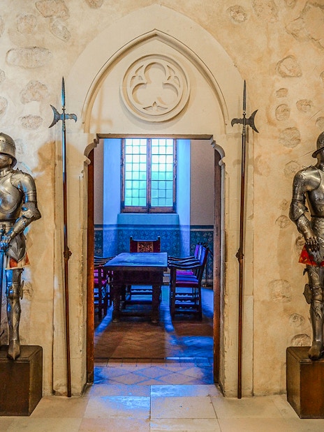 Suits of armor in a historic room, Segovia & Avila Day Trip from Madrid.