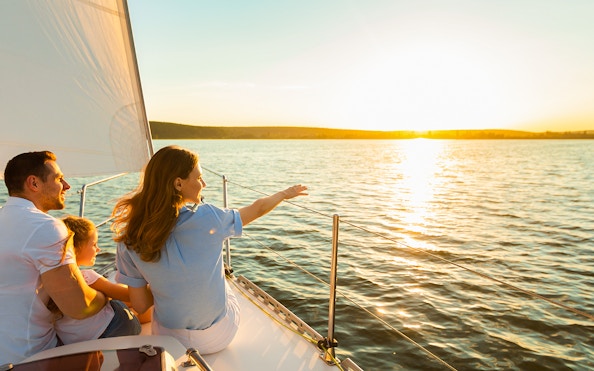 Family enjoying sunset cruise on Gdansk River with Prosecco.