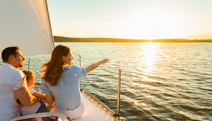 Family enjoying sunset cruise on Gdansk River with Prosecco.