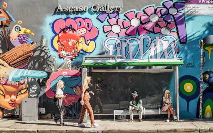 Wynwood Walls Miami bus stop with vibrant mural and graffiti art.
