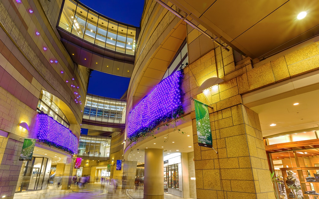 Modern architecture with illuminated purple lights at Namba Parks, Osaka.