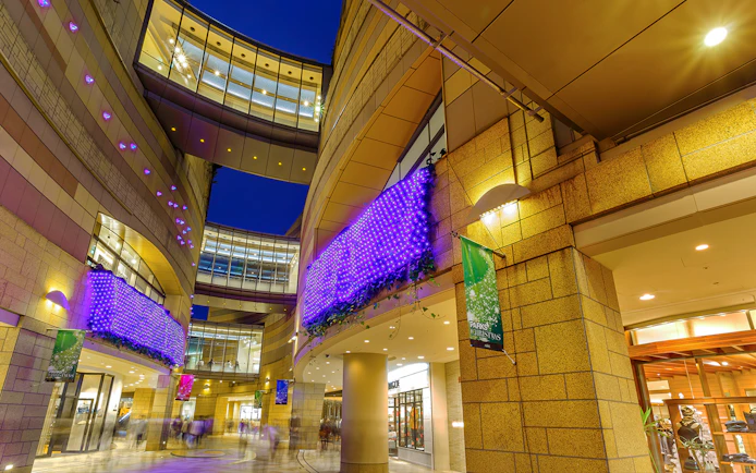 Modern architecture with illuminated purple lights at Namba Parks, Osaka.