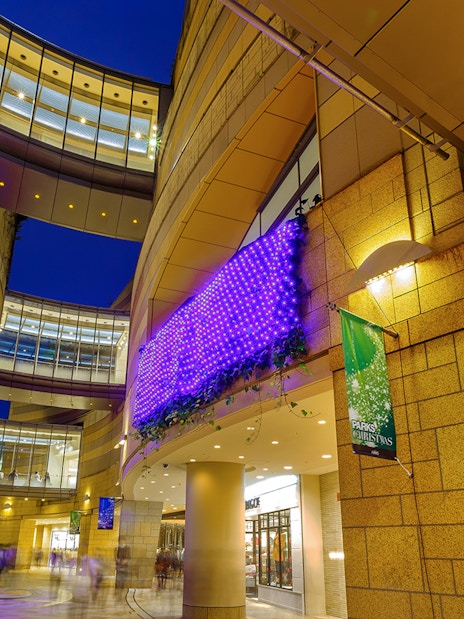 Modern architecture with illuminated purple lights at Namba Parks, Osaka.