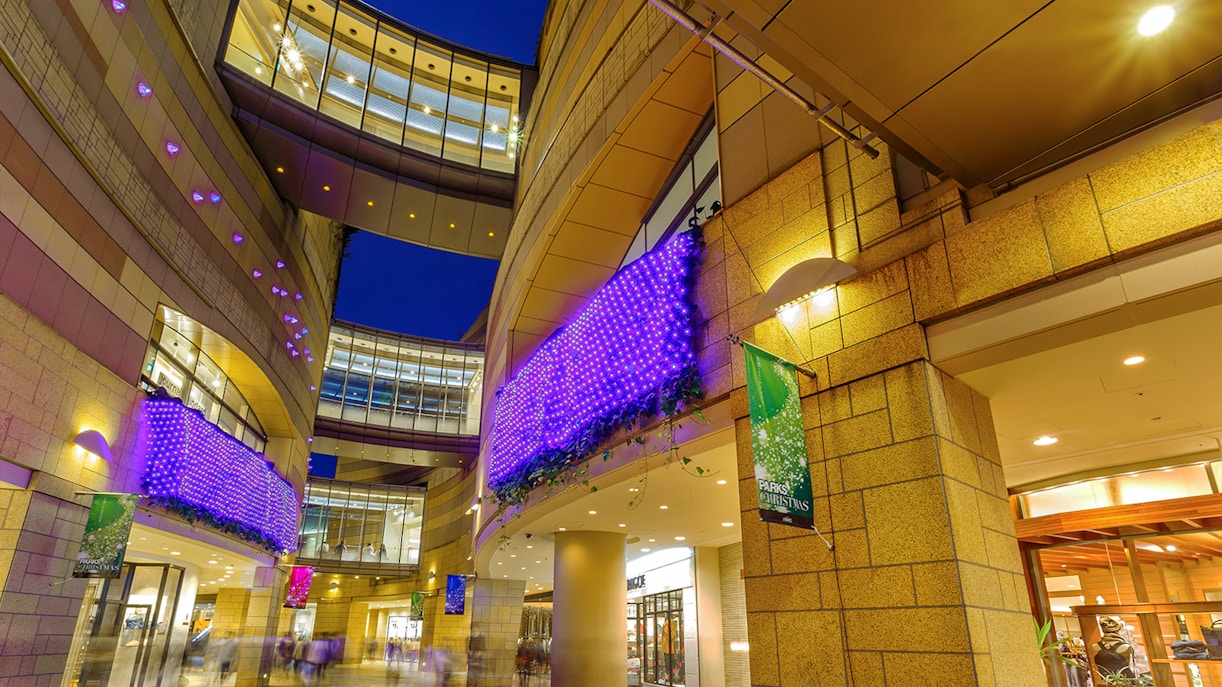 Modern architecture with illuminated purple lights at Namba Parks, Osaka.