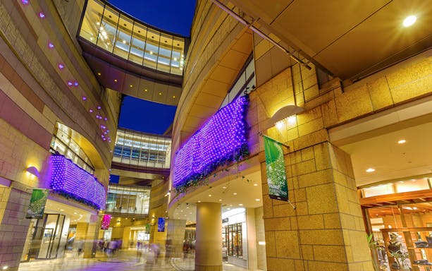 Modern architecture with illuminated purple lights at Namba Parks, Osaka.