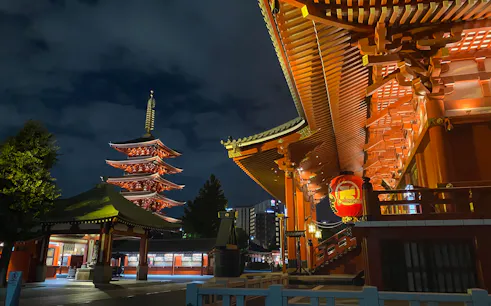 Sensoji Temple pagoda illuminated at night during Tokyo half-day tour.