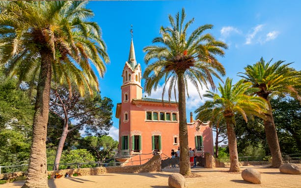 Gaudi House Museum surrounded by palm trees in Park Güell, Barcelona, Spain.