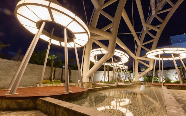 Modern outdoor structure at Spa Land Centum City, Busan, with illuminated circular designs.