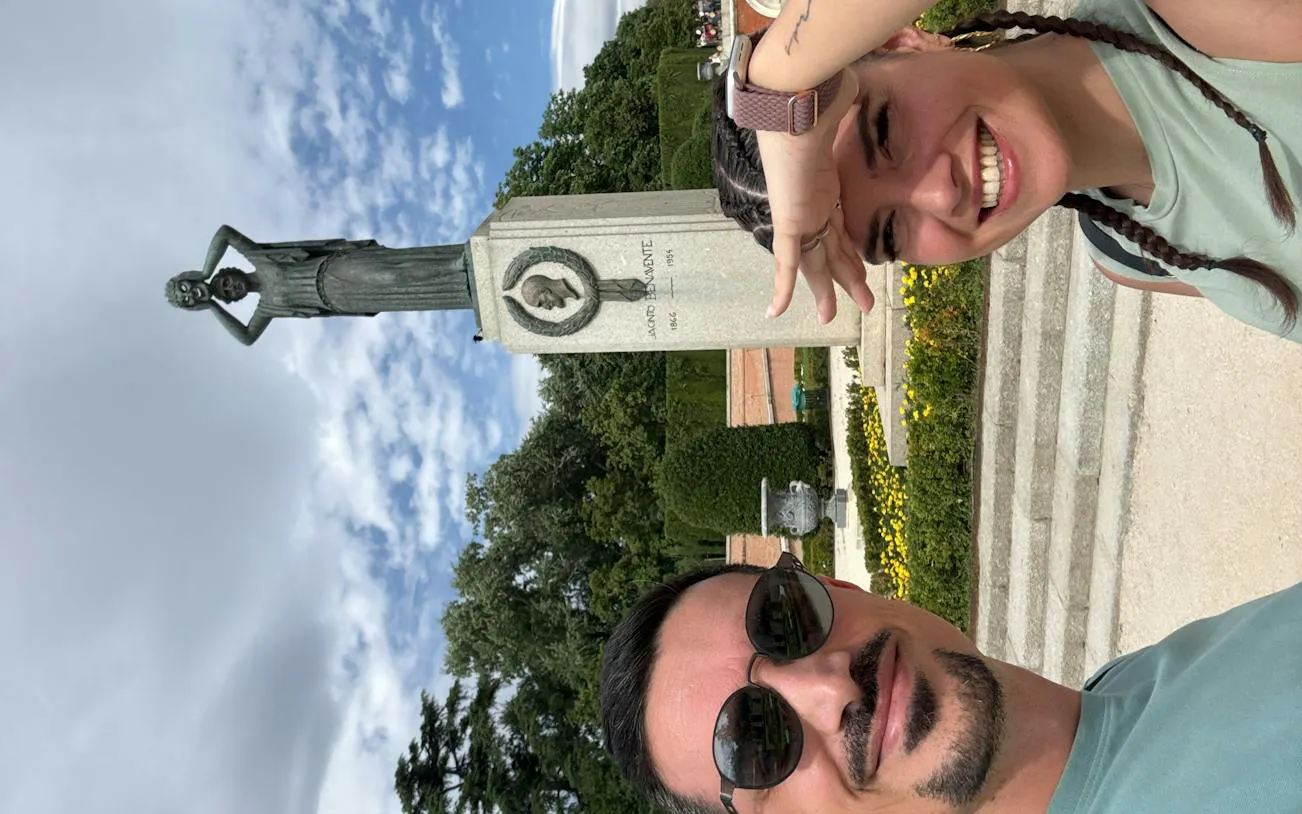 Statue in Retiro Park, Madrid, with visitors enjoying a self-guided exploration game.