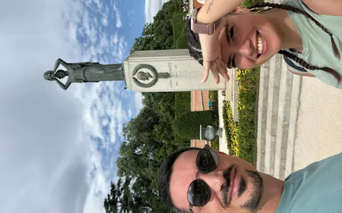 Statue in Retiro Park, Madrid, with visitors enjoying a self-guided exploration game.