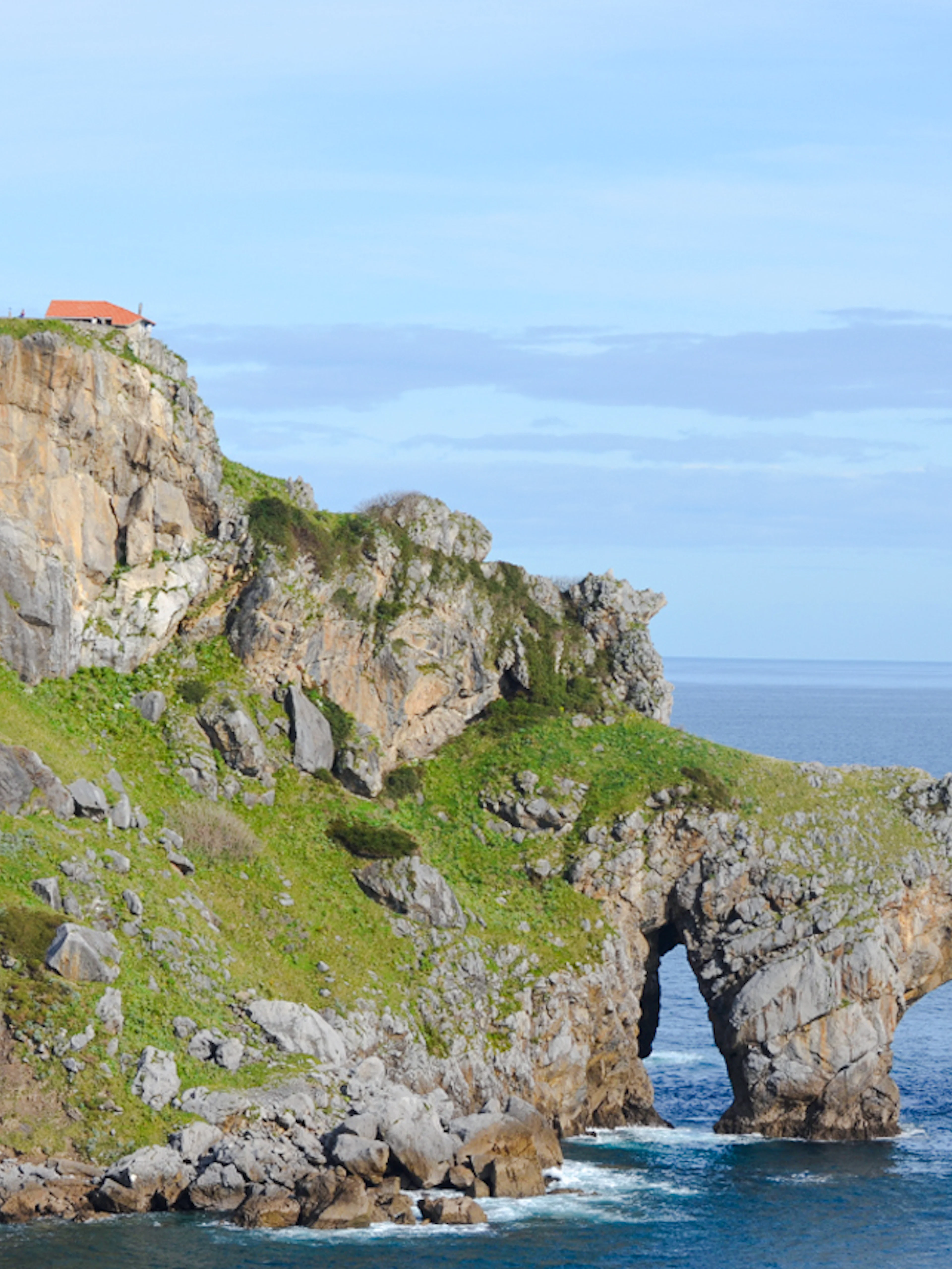 Rocky island with chapel and archway at San Juan de Gaztelugatxe, near San Sebastian.