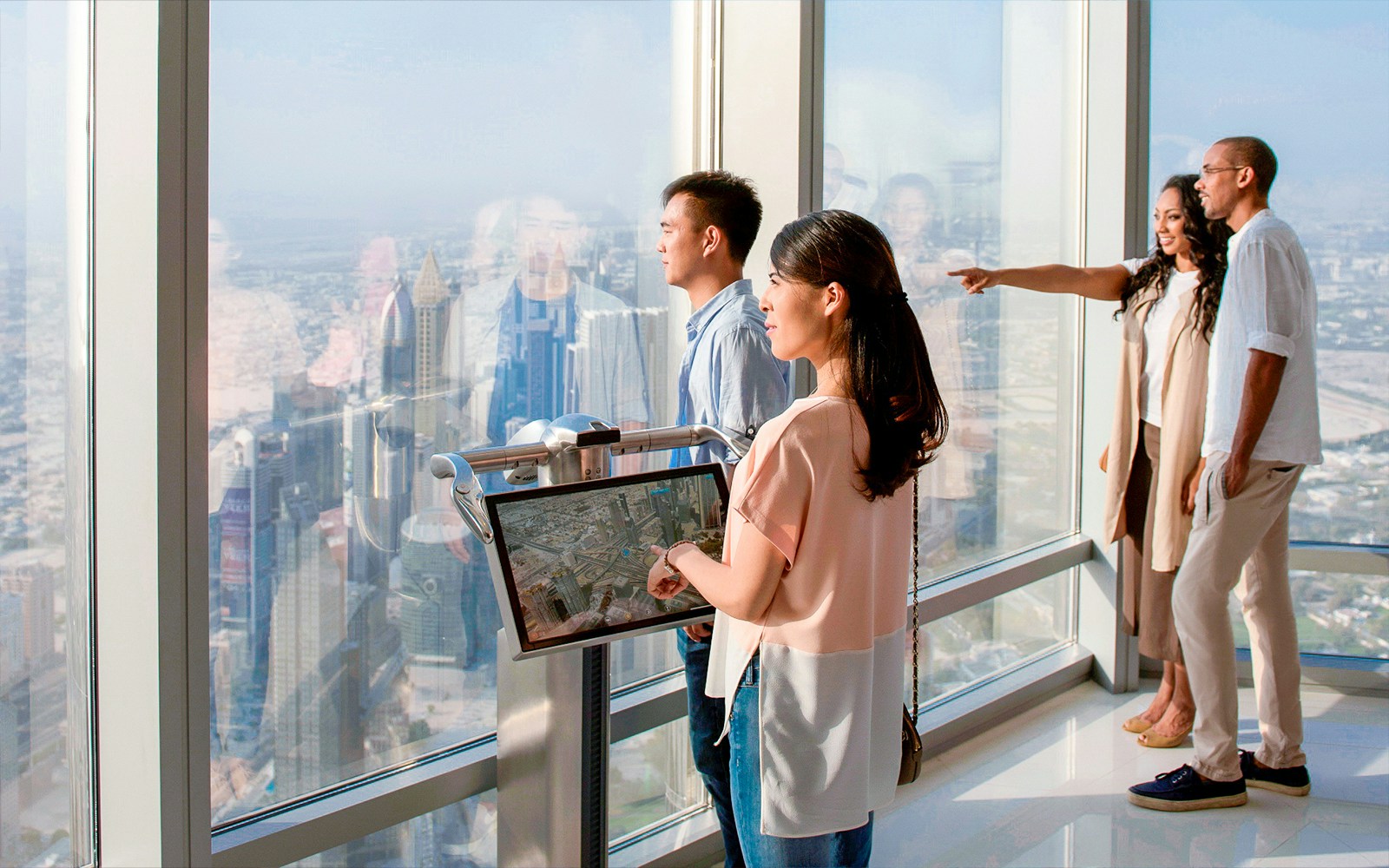A child using the electronic telescope to see the view at Level 124, Burj Khalifa