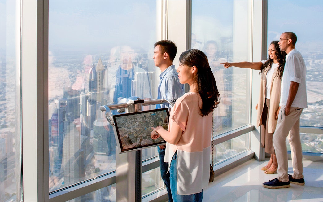 Visitors enjoying the view from Burj Khalifa Levels 124 & 125 observation deck in Dubai.